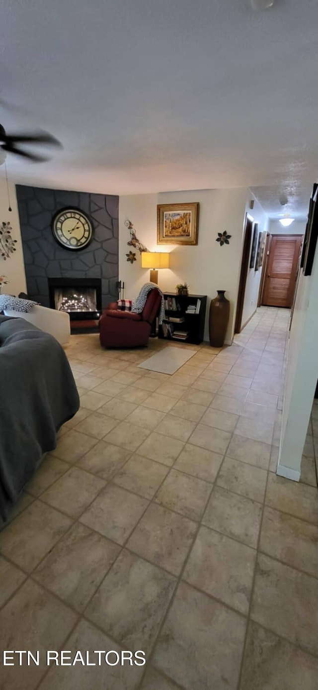 bedroom featuring a large fireplace and light tile patterned floors