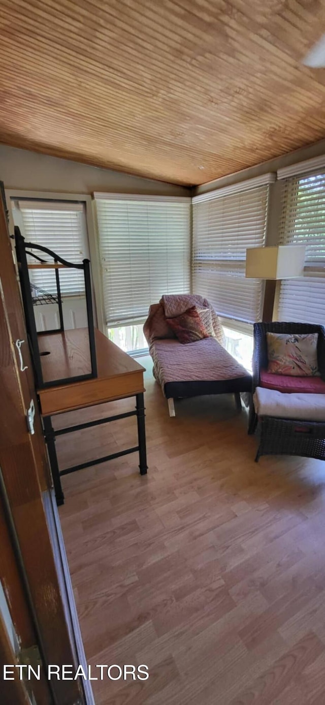 bedroom with wood ceiling and wood finished floors
