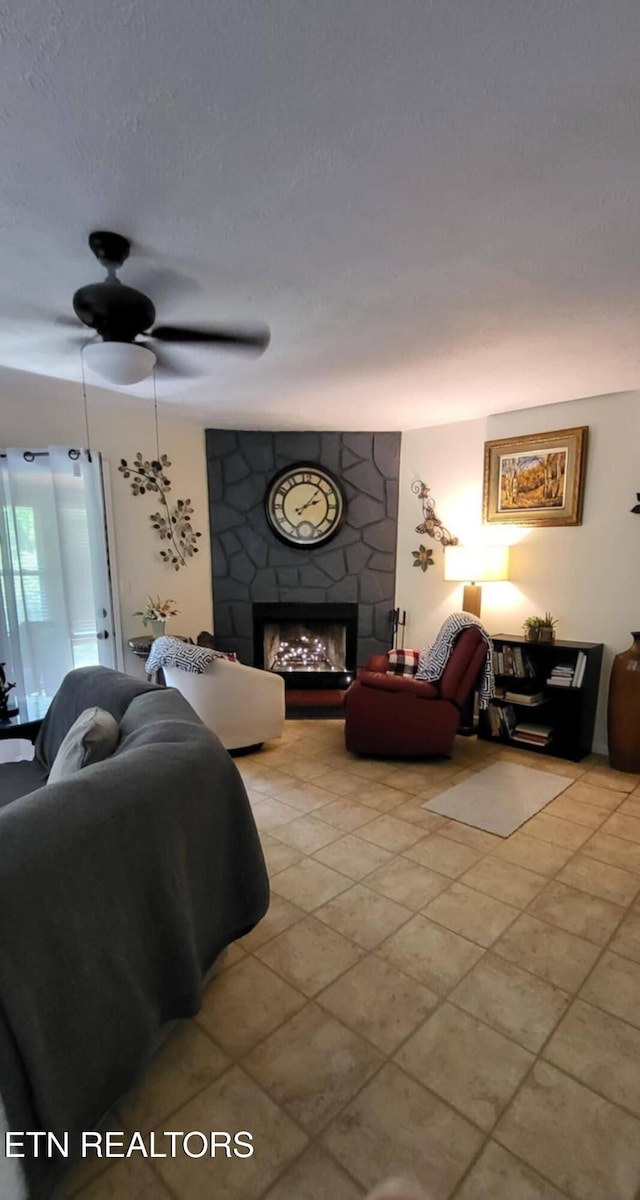 living room featuring a large fireplace and light tile patterned floors