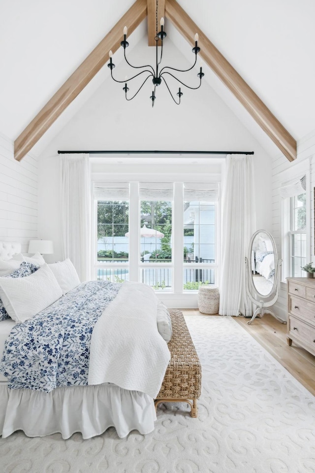 bedroom featuring a chandelier and wood finished floors