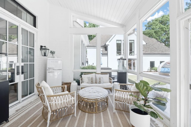sunroom with healthy amount of natural light, lofted ceiling, and wooden ceiling