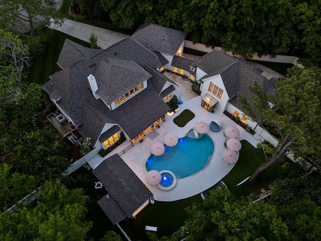 aerial view of property and surrounding area with a pool