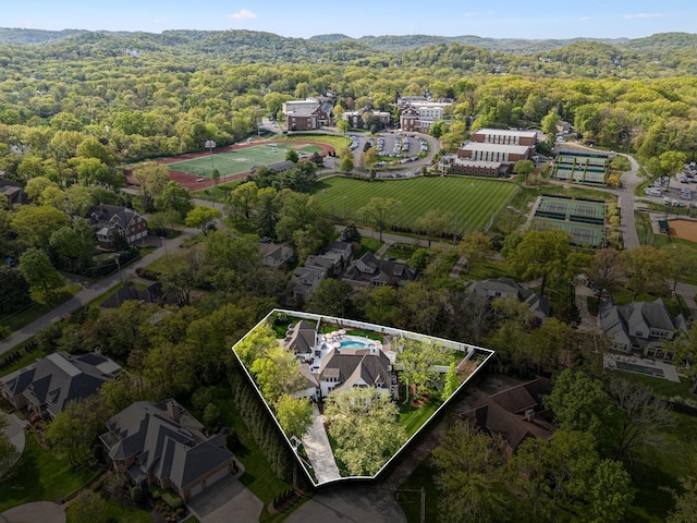 aerial view of property and surrounding area with a forest and property boundaries highlighted