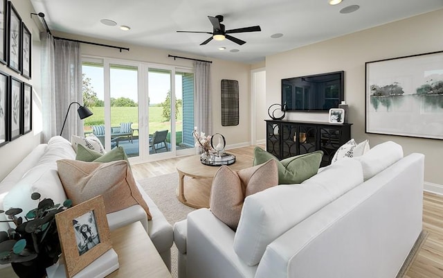 living room with baseboards, ceiling fan, light wood finished floors, and recessed lighting