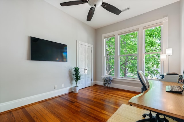 office area with baseboards, wood finished floors, and a ceiling fan