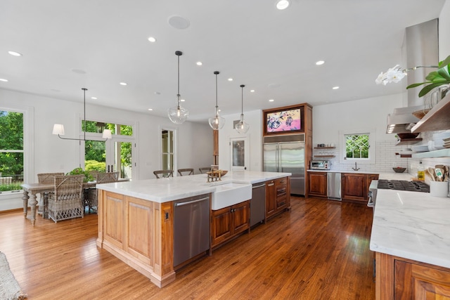 kitchen with stainless steel appliances, open shelves, plenty of natural light, recessed lighting, and wood finished floors