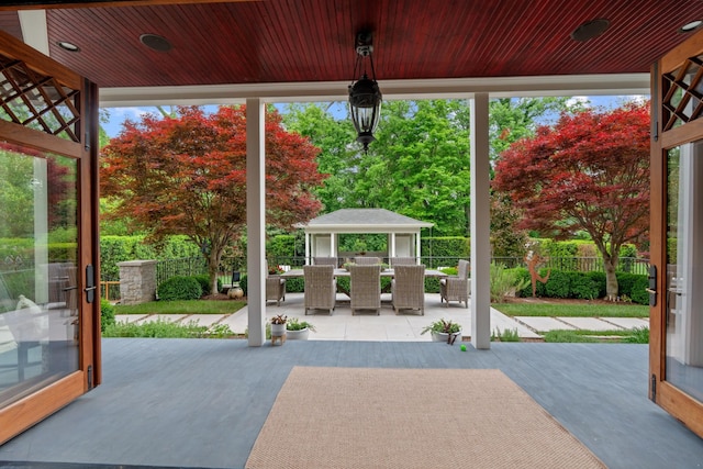 entryway with a wall of windows, wood finished floors, and wood ceiling