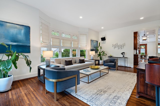 living room with wood finished floors, recessed lighting, baseboards, and a chandelier