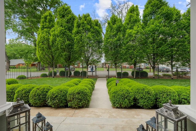 view of home's community with fence