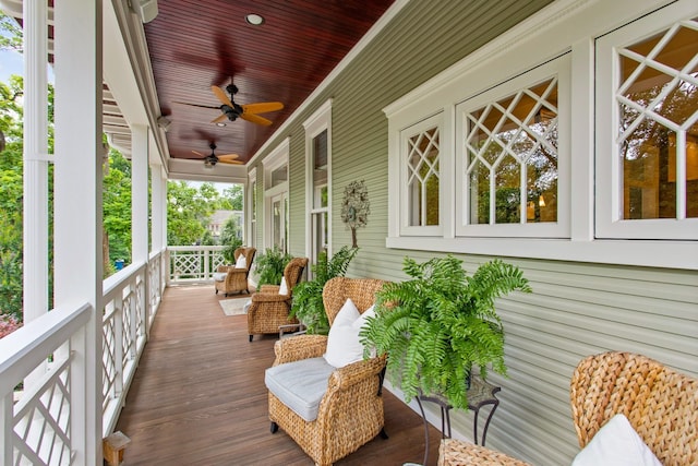 wooden deck featuring ceiling fan and covered porch