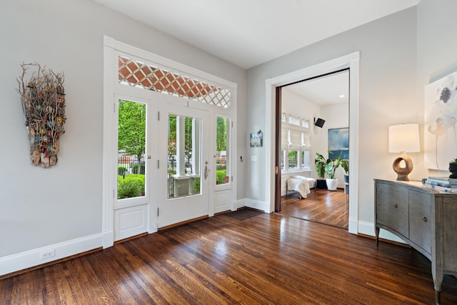 foyer featuring wood finished floors and baseboards