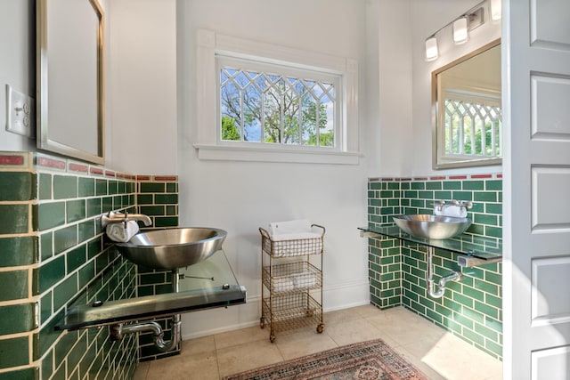 bathroom featuring healthy amount of natural light, tile patterned floors, and a sink