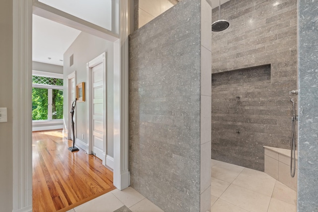 full bathroom with walk in shower, tile walls, and tile patterned flooring