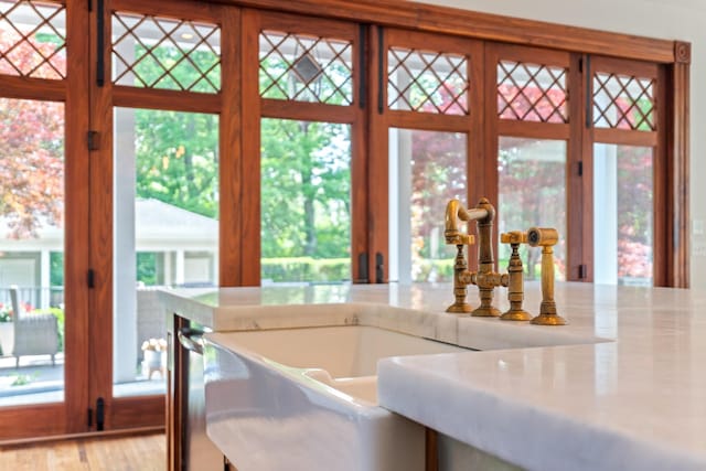kitchen with a sink, light wood-type flooring, and light countertops