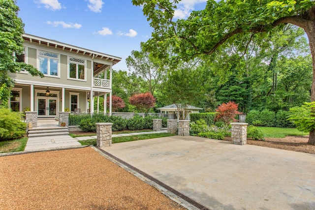 view of patio / terrace with french doors, ceiling fan, a porch, and fence