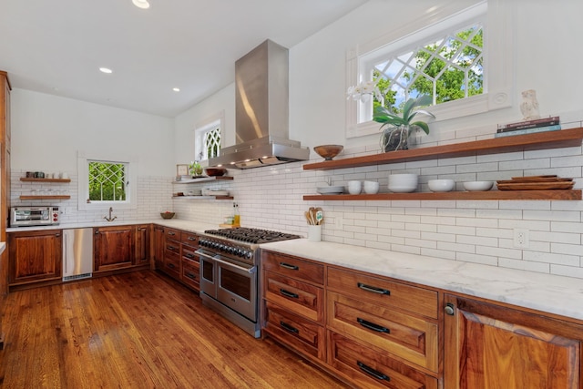 kitchen with open shelves, double oven range, range hood, tasteful backsplash, and light stone countertops
