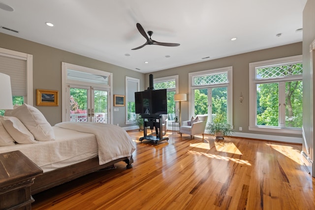 bedroom with access to exterior, french doors, light wood-type flooring, recessed lighting, and baseboards