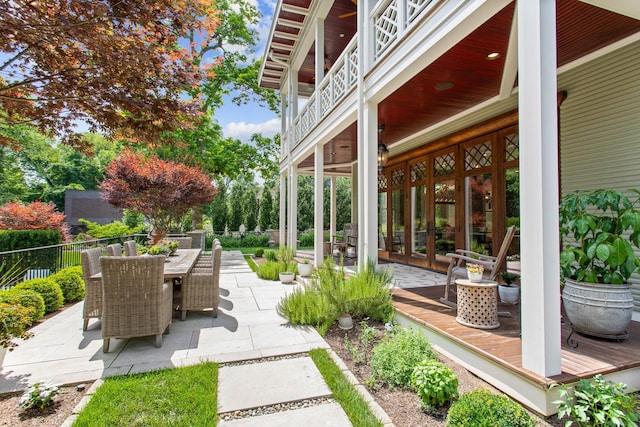 view of yard with outdoor dining area, a patio area, fence, a ceiling fan, and french doors