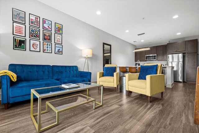 living area with dark wood-style floors and recessed lighting