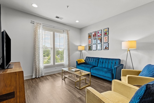 living room featuring wood finished floors, baseboards, and recessed lighting