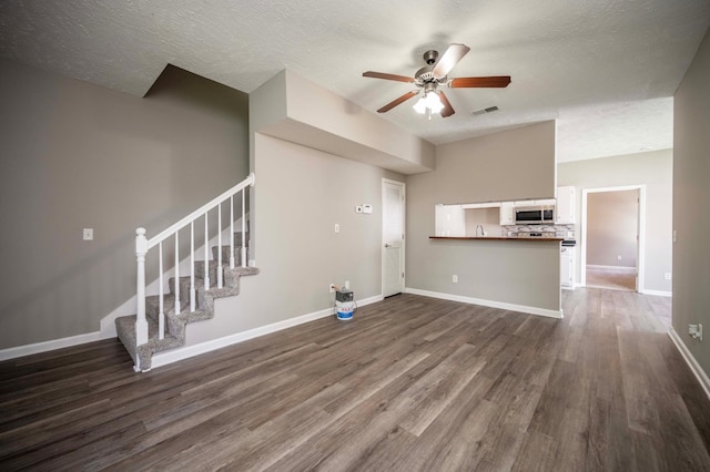 2642 Sewanee Pl, Murfreesboro, TN 37128 - unfurnished living room with a ceiling fan, dark wood-style flooring, stairs, baseboards, and a textured ceiling
