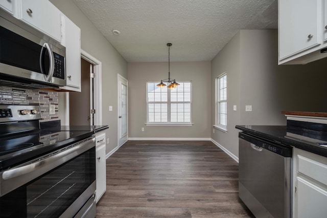 2642 Sewanee Pl, Murfreesboro, TN 37128 - kitchen with stainless steel appliances, backsplash, white cabinetry, dark wood-style floors, and dark countertops