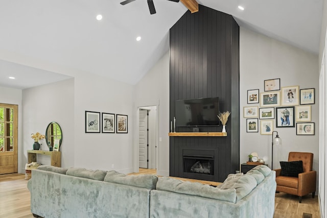 12684 US Highway 41, Tracy City, TN 37387 - living area with high vaulted ceiling, light wood-type flooring, a ceiling fan, a large fireplace, and baseboards