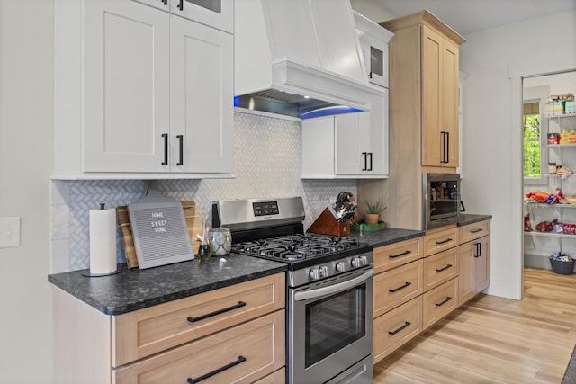 12684 US Highway 41, Tracy City, TN 37387 - kitchen with stainless steel range with gas cooktop, custom range hood, tasteful backsplash, and light wood-style floors