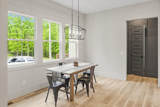 12684 US Highway 41, Tracy City, TN 37387 - dining space featuring healthy amount of natural light, baseboards, a chandelier, and light wood finished floors