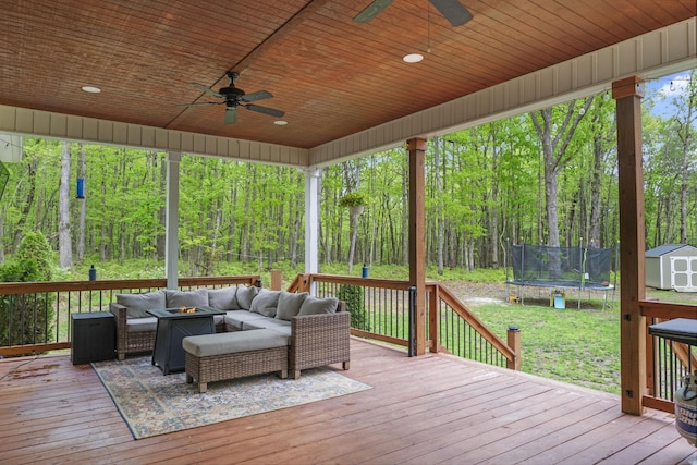 12684 US Highway 41, Tracy City, TN 37387 - deck with a storage shed, a trampoline, an outdoor living space with a fire pit, a ceiling fan, and an outdoor structure