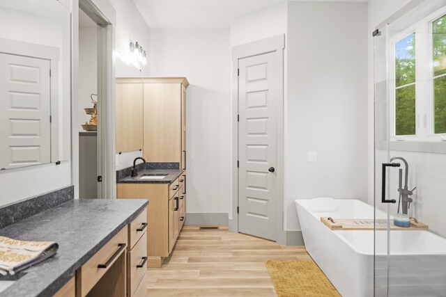 12684 US Highway 41, Tracy City, TN 37387 - bathroom with wood finished floors, a freestanding bath, and vanity
