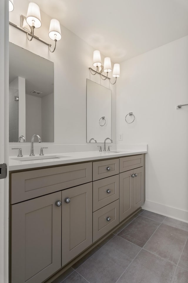bathroom featuring tile patterned flooring, baseboards, and double vanity