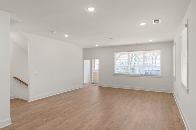 unfurnished living room featuring light wood-type flooring, recessed lighting, and baseboards