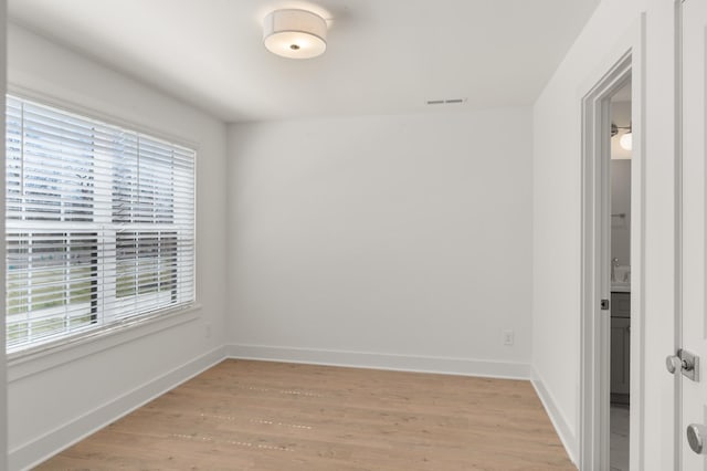 unfurnished room with light wood finished floors and baseboards
