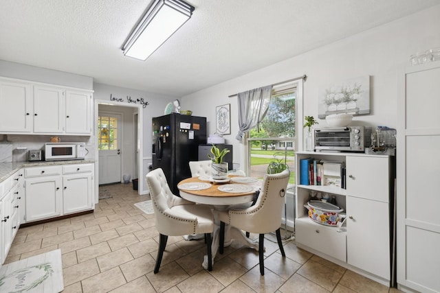 405 Mockingbird Dr, Mount Pleasant, TN 38474 - dining space featuring a textured ceiling and light tile patterned flooring