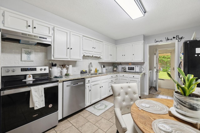 405 Mockingbird Dr, Mount Pleasant, TN 38474 - kitchen with appliances with stainless steel finishes, under cabinet range hood, a sink, white cabinetry, and decorative backsplash