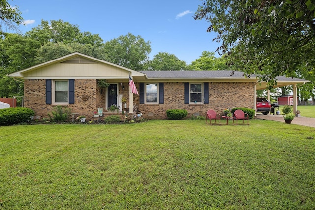 405 Mockingbird Dr, Mount Pleasant, TN 38474 - ranch-style house featuring a front yard, brick siding, a carport, and driveway