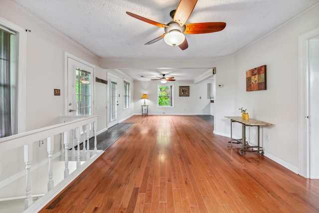 2046 Scribners Mill Rd, Culleoka, TN 38451 - empty room featuring a ceiling fan, wood finished floors, ornamental molding, a textured ceiling, and baseboards