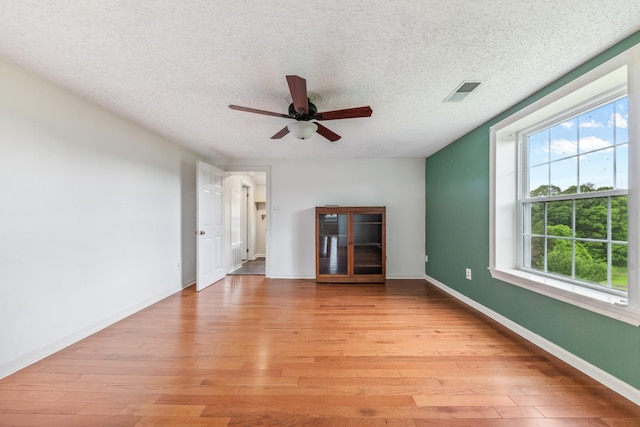 2046 Scribners Mill Rd, Culleoka, TN 38451 - unfurnished living room featuring a ceiling fan, light wood-style flooring, a textured ceiling, and baseboards
