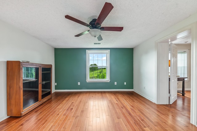 2046 Scribners Mill Rd, Culleoka, TN 38451 - empty room featuring a textured ceiling, light wood-style flooring, a ceiling fan, and baseboards