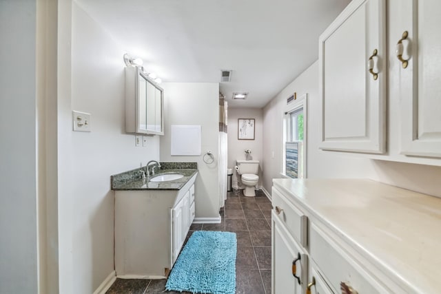 2046 Scribners Mill Rd, Culleoka, TN 38451 - bathroom with toilet, vanity, baseboards, and tile patterned floors