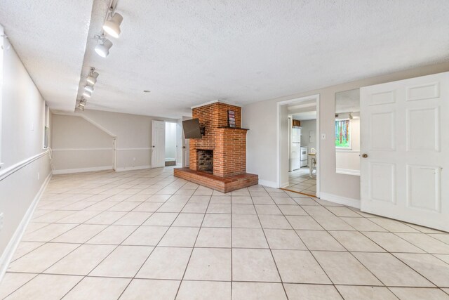 2046 Scribners Mill Rd, Culleoka, TN 38451 - unfurnished living room featuring a textured ceiling, a fireplace, light tile patterned floors, and baseboards