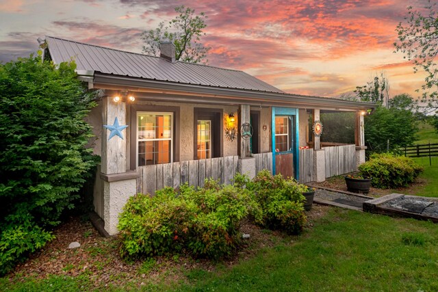 2046 Scribners Mill Rd, Culleoka, TN 38451 - view of property exterior with a porch, metal roof, a chimney, and fence