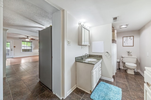 2046 Scribners Mill Rd, Culleoka, TN 38451 - bathroom featuring toilet, ceiling fan, baseboards, and vanity