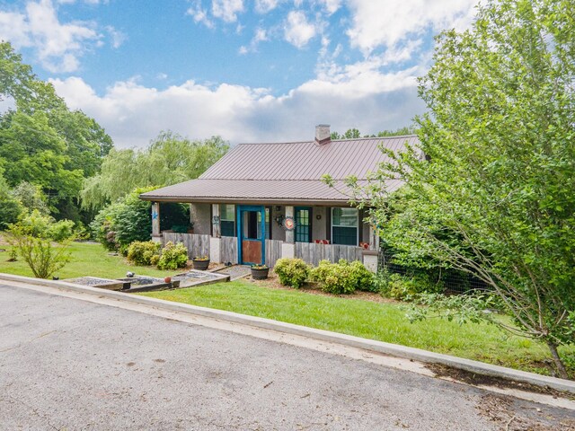 2046 Scribners Mill Rd, Culleoka, TN 38451 - view of front of property featuring covered porch, a chimney, metal roof, and a front lawn