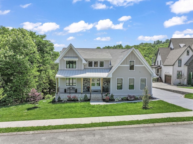 304 Cedar Hollow Ct, Lebanon, TN 37087 - view of front facade featuring board and batten siding, a porch, a front yard, a standing seam roof, and metal roof