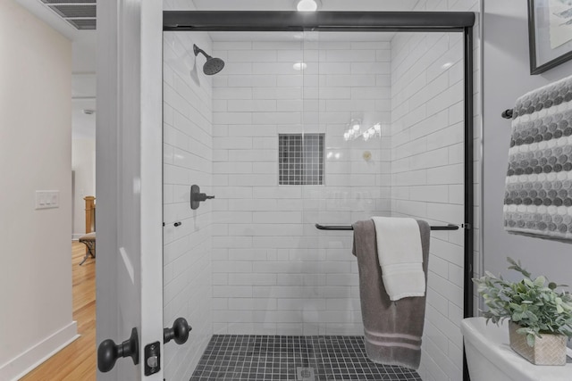 304 Cedar Hollow Ct, Lebanon, TN 37087 - bathroom with a stall shower, wood finished floors, toilet, and baseboards