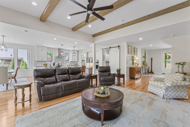 304 Cedar Hollow Ct, Lebanon, TN 37087 - living room featuring a barn door, light wood-style flooring, beamed ceiling, a ceiling fan, and recessed lighting
