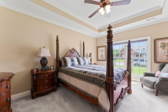 bedroom featuring carpet floors, crown molding, a raised ceiling, a ceiling fan, and baseboards