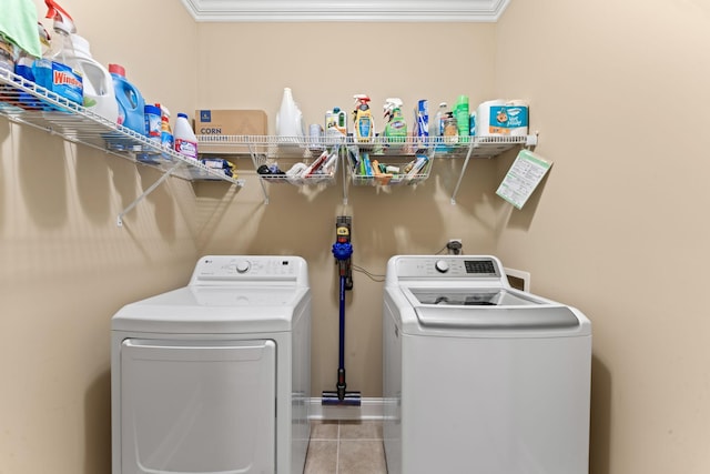 washroom with separate washer and dryer, tile patterned floors, and ornamental molding
